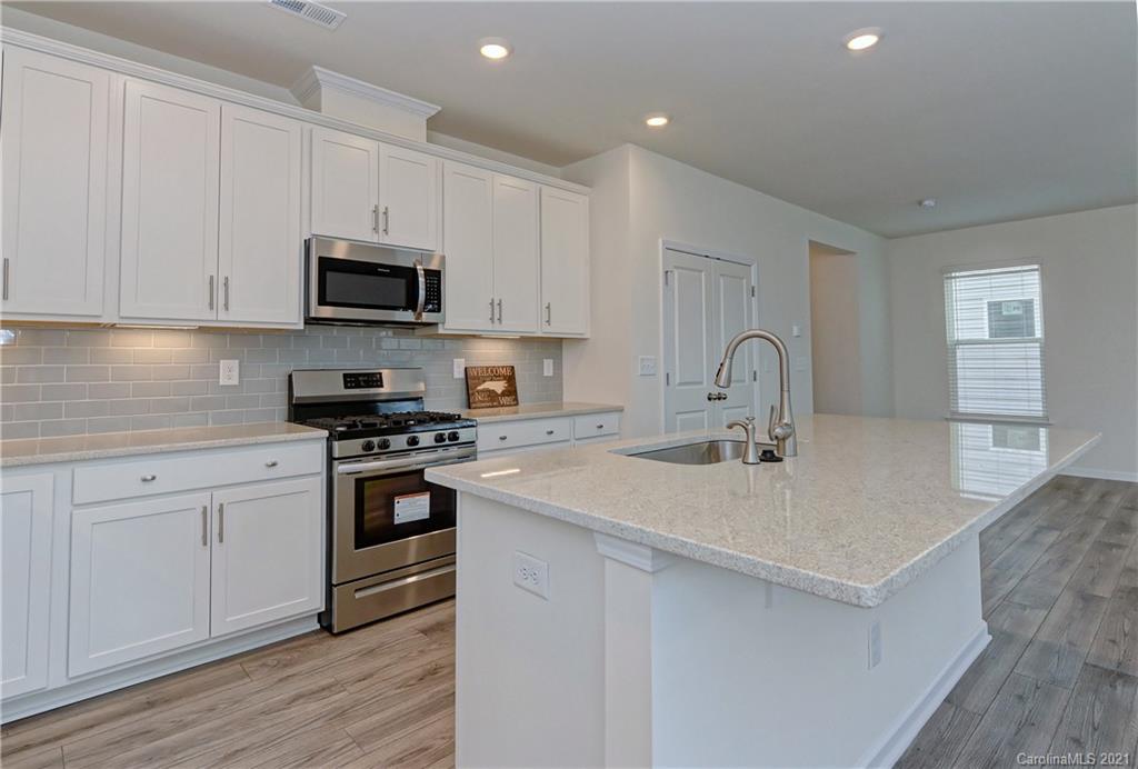 2014 Blue Pond Road Matthews, NC 28104 - Photo 13 of 32 a kitchen with stainless steel appliances granite countertop a sink and white cabinets