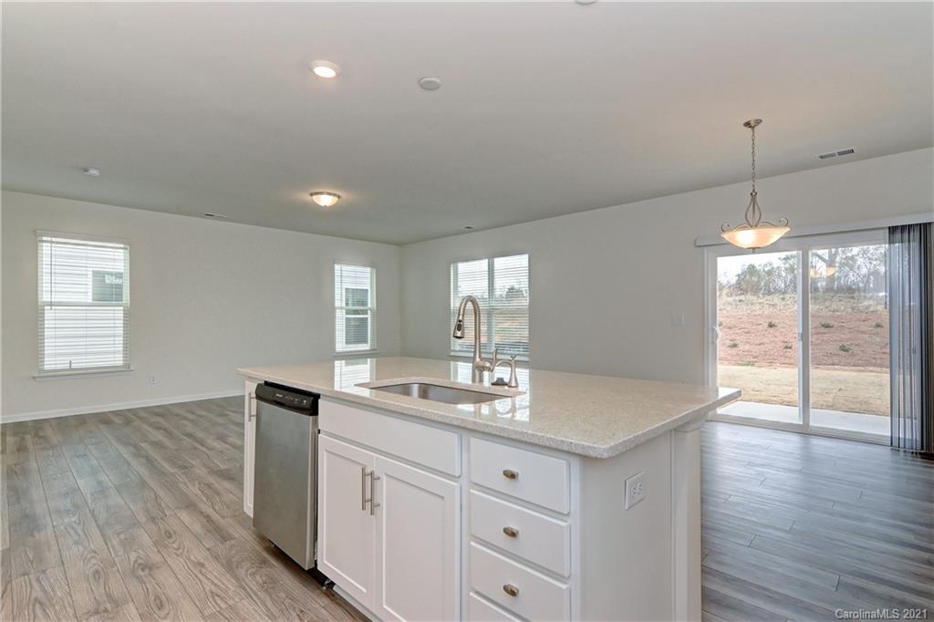 2014 Blue Pond Road Matthews, NC 28104 - Photo 14 of 32 a kitchen with granite countertop a sink and dishwasher with wooden floor