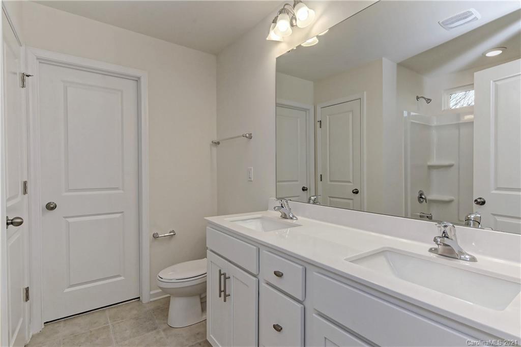 2014 Blue Pond Road Matthews, NC 28104 - Photo 26 of 32 a bathroom with a toilet a sink and mirror