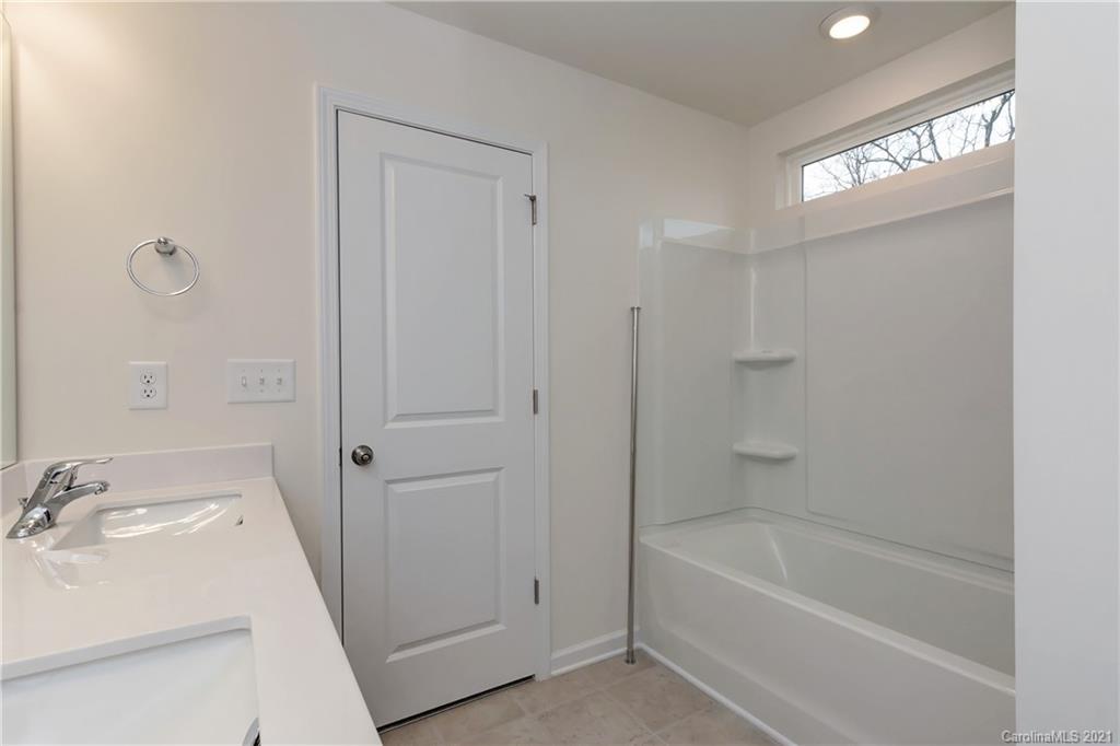 2014 Blue Pond Road Matthews, NC 28104 - Photo 27 of 32 a bathroom with a sink a tub and a mirror