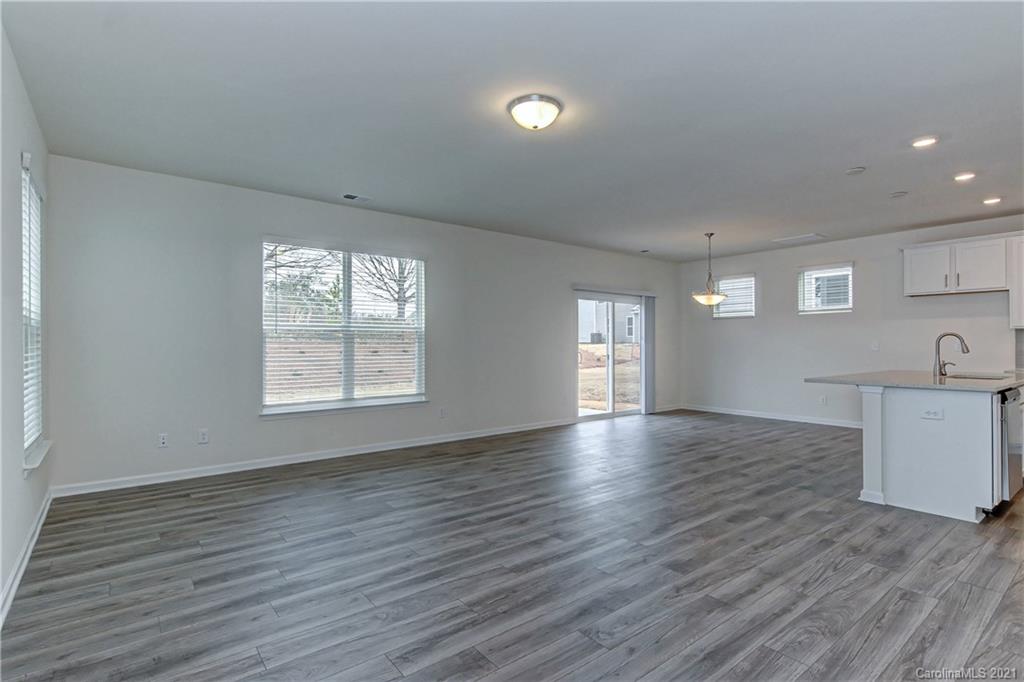 2014 Blue Pond Road Matthews, NC 28104 - Photo 7 of 32 an empty room with wooden floor and windows