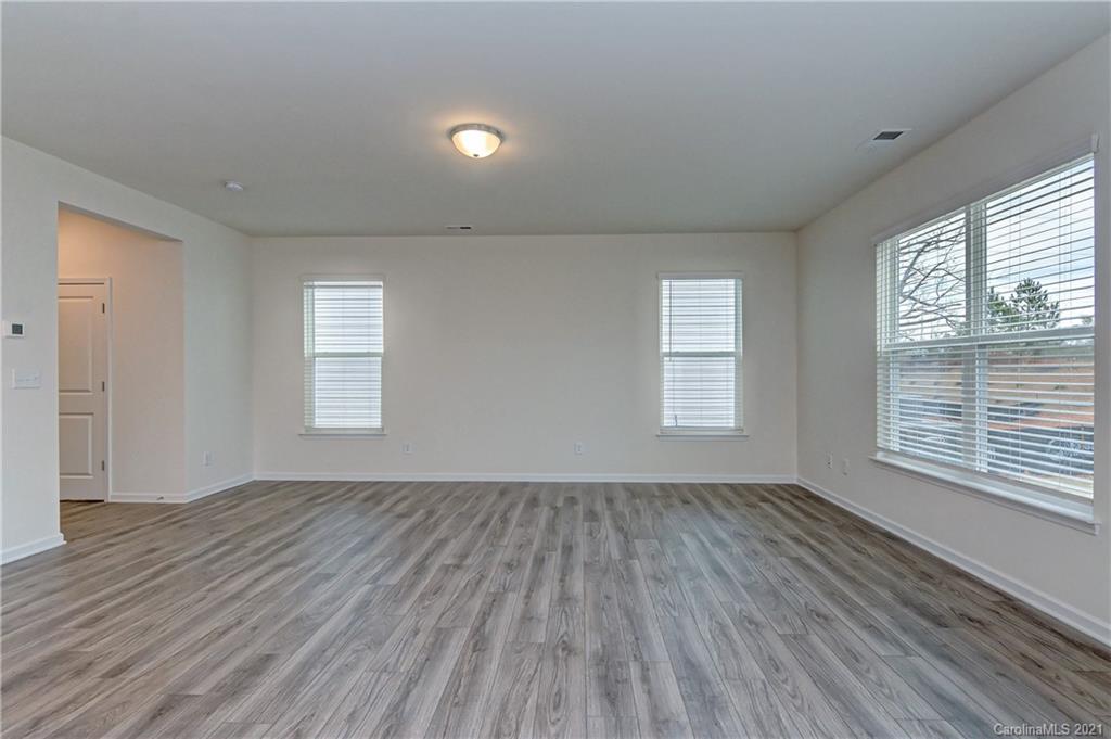 2014 Blue Pond Road Matthews, NC 28104 - Photo 8 of 32 an empty room with wooden floor and windows