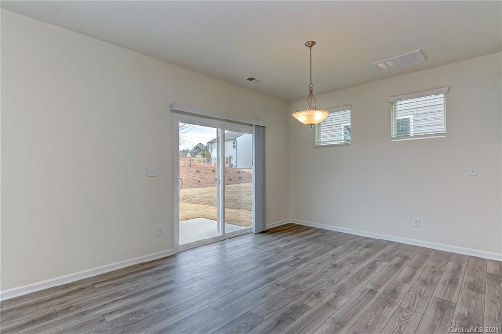 2014 Blue Pond Road Matthews, NC 28104 - Photo 9 of 32 a view of empty room with wooden floor and fan