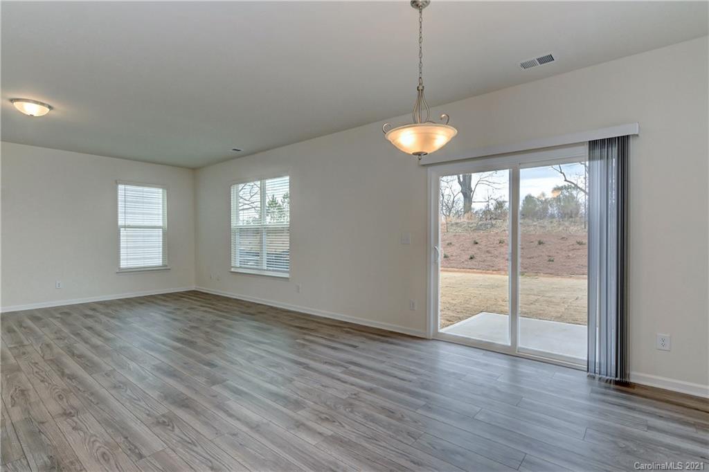 2014 Blue Pond Road Matthews, NC 28104 - Photo 10 of 32 a view of an empty room with wooden floor and a window