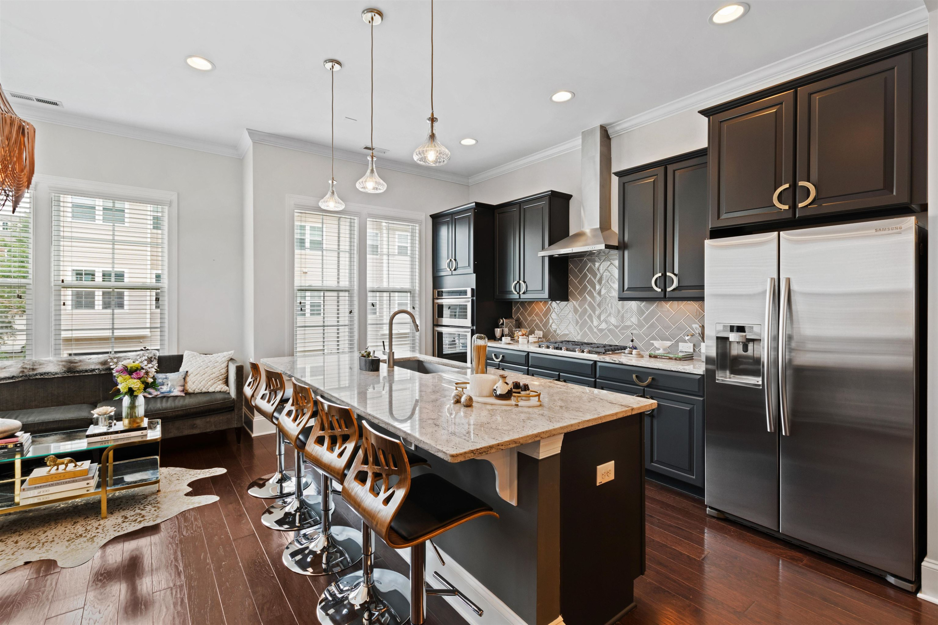 220 Penley Circle Raleigh, NC 27609 - Photo 11 of 56 a kitchen with stainless steel appliances granite countertop a refrigerator a stove a sink a dining table and chairs with wooden floor