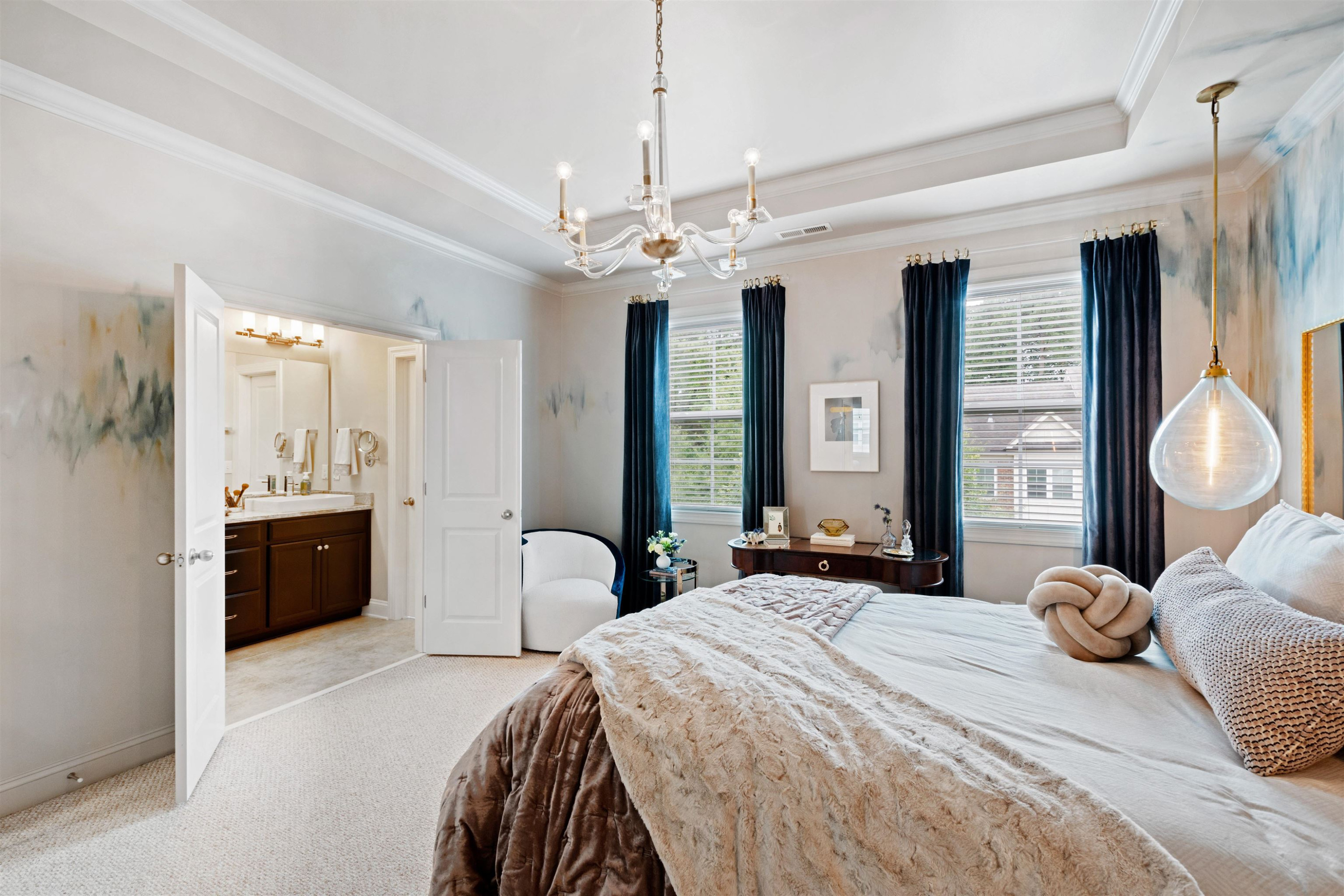 220 Penley Circle Raleigh, NC 27609 - Photo 32 of 56 a bedroom with a large bed and a chandelier