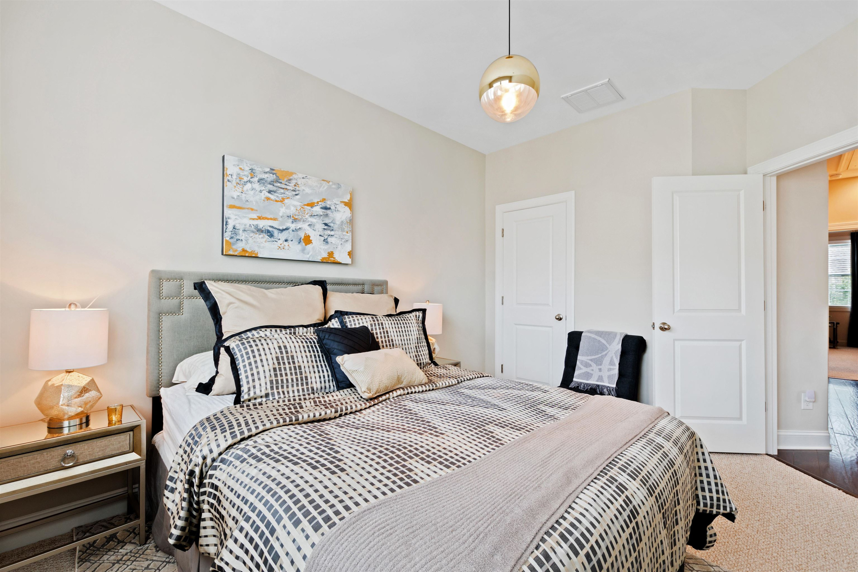 220 Penley Circle Raleigh, NC 27609 - Photo 38 of 56 a bedroom with a bed and a chandelier