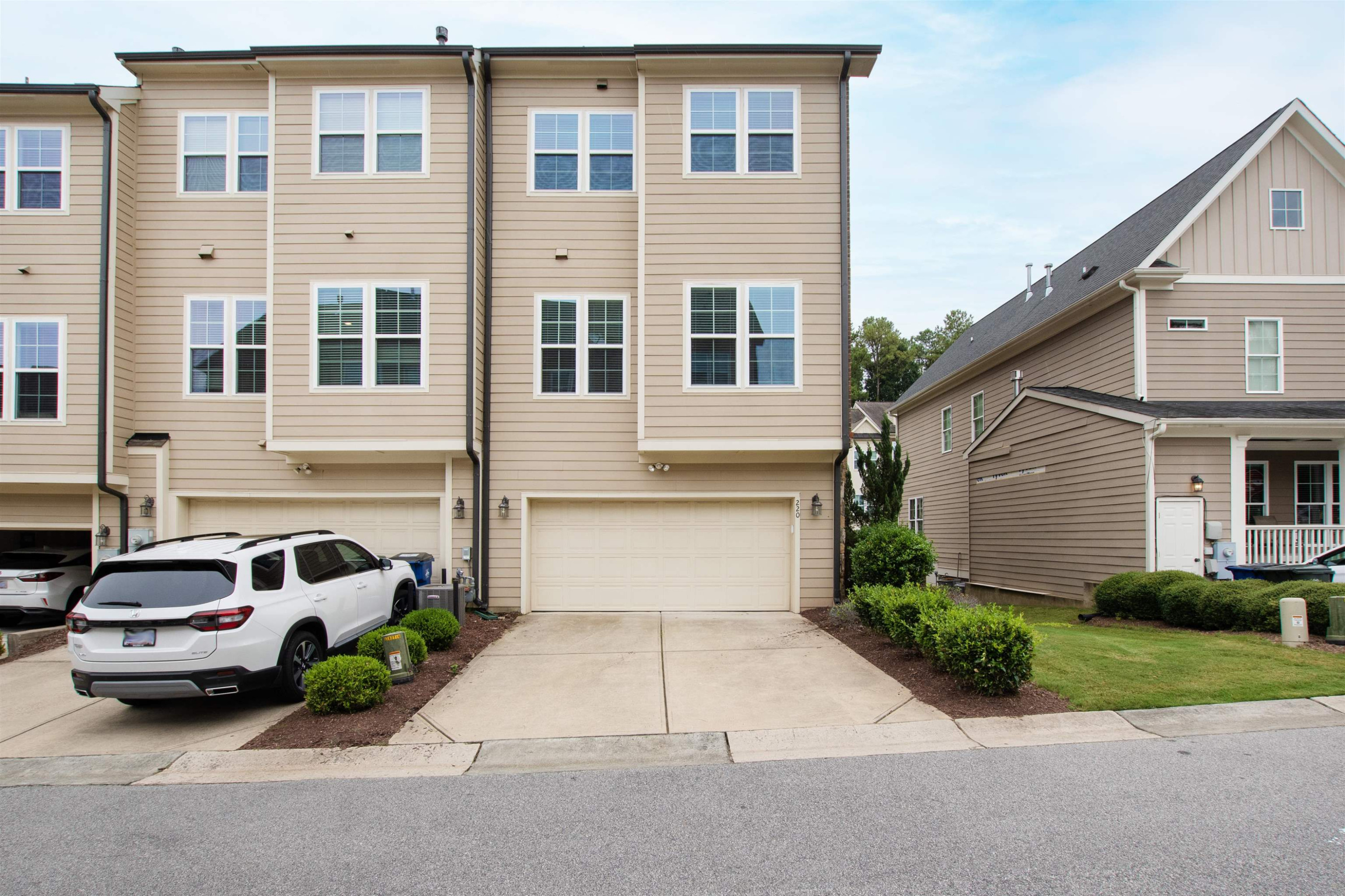 220 Penley Circle Raleigh, NC 27609 - Photo 54 of 56 a front view of a house with a garden and parking