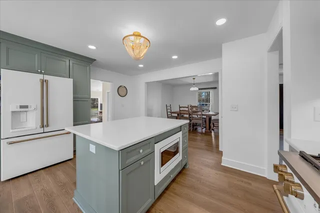 a spacious bedroom with a bed and a chandelier