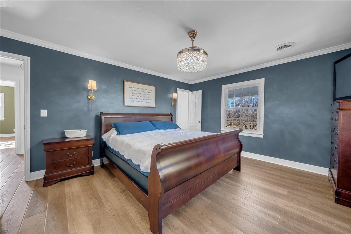 251 Miller Road Hillsboro, TN 37342 - Photo 42 of 80 a spacious bedroom with a bed and a chandelier