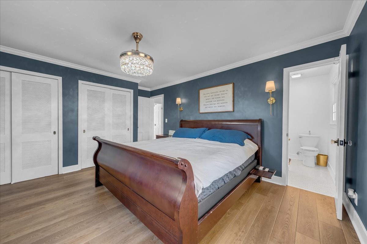 251 Miller Road Hillsboro, TN 37342 - Photo 43 of 80 a spacious bedroom with a bed and a chandelier