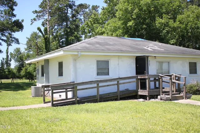 a view of a house with pool and a yard