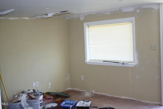 a room with a window and flowerpot