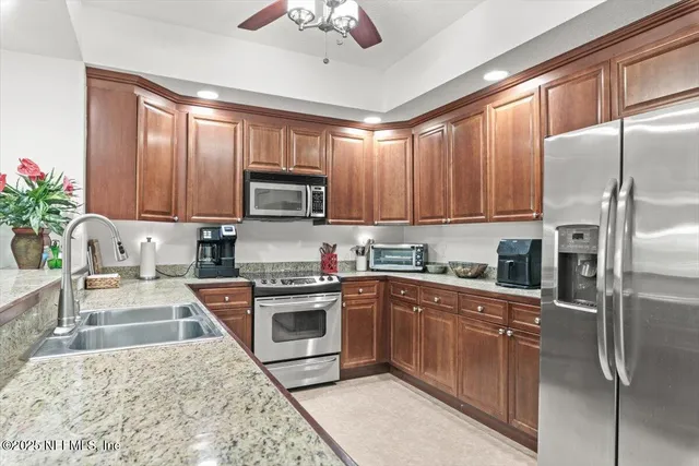 an aerial view of lake and residential houses with outdoor space