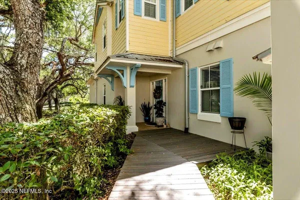 a kitchen with stainless steel appliances granite countertop a stove top oven a sink dishwasher a dining table and chairs with wooden floor