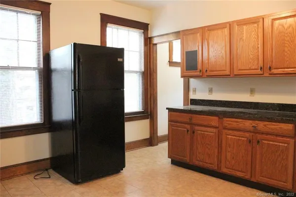 a kitchen with stainless steel appliances granite countertop a refrigerator and a cabinets
