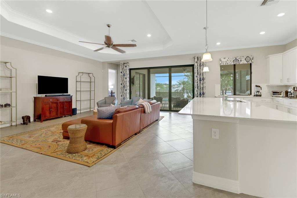 1878 Mustique Street Naples, FL 34120 - Photo 12 of 50 a living room with fireplace furniture and a flat screen tv