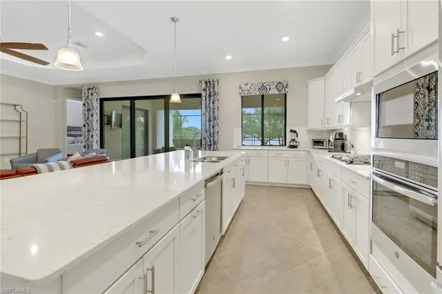 a large white kitchen with a large window