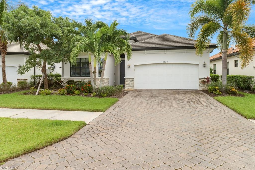 1878 Mustique Street Naples, FL 34120 - Photo 2 of 50 a front view of a house with a yard and garage