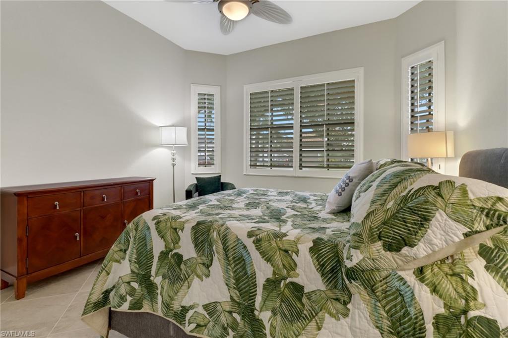 1878 Mustique Street Naples, FL 34120 - Photo 22 of 50 a bedroom with a bed and window