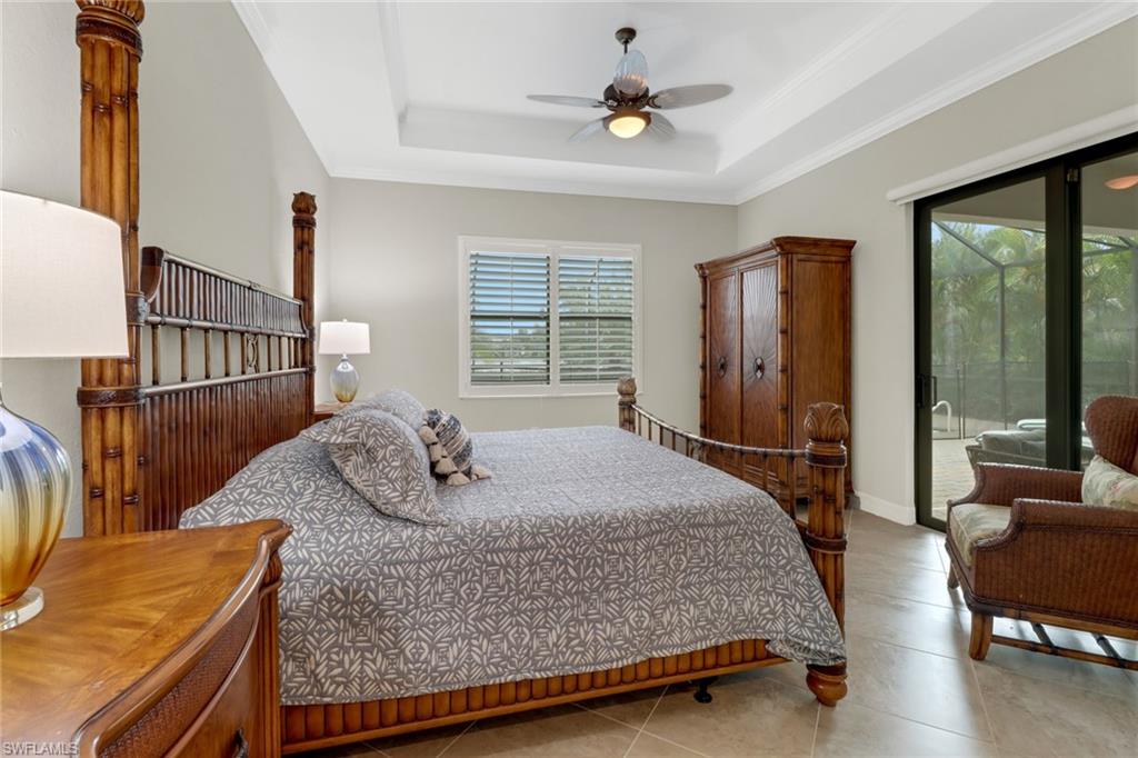 1878 Mustique Street Naples, FL 34120 - Photo 23 of 50 a bedroom with a bed a window and walk in closet
