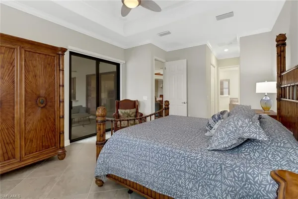 a bedroom with a bed and large windows