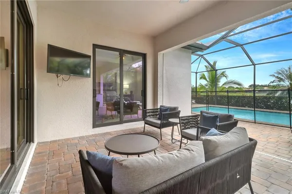a living room with furniture and a floor to ceiling window