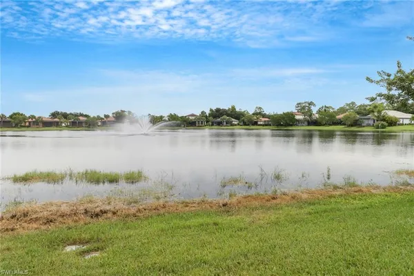 a view of a lake with houses in the back