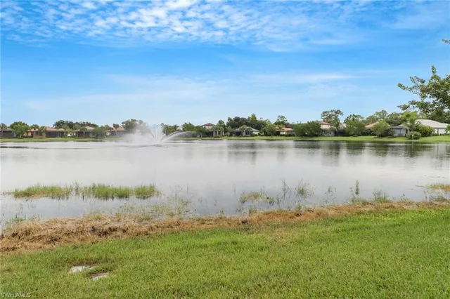 a view of a lake with houses in the back
