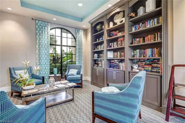a living room with furniture and a book shelf