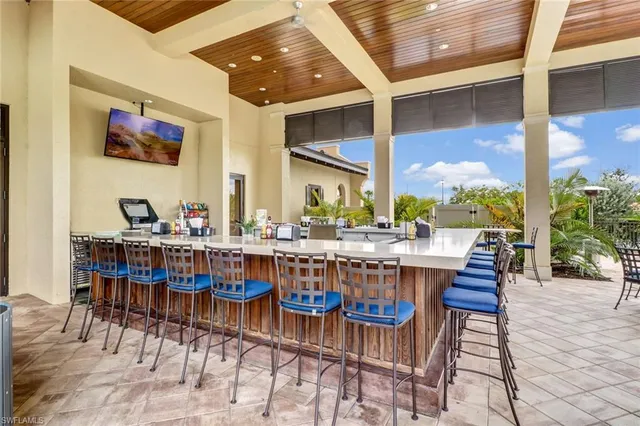 a view of a house with pool and chairs