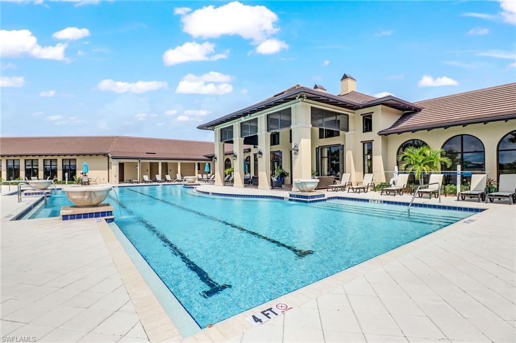 1878 Mustique Street Naples, FL 34120 - Photo 49 of 50 a view of a house with pool and chairs