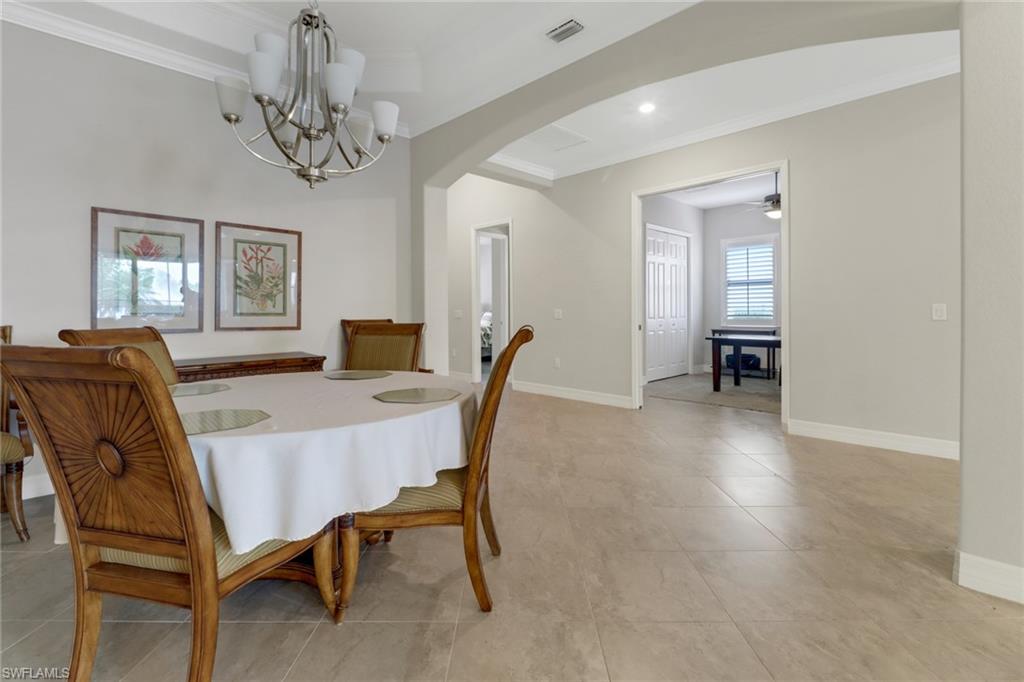 1878 Mustique Street Naples, FL 34120 - Photo 6 of 50 a view of a dining room with furniture and wooden floor