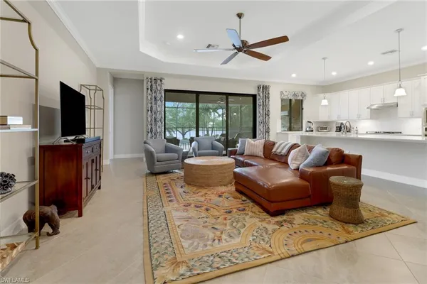 a living room with furniture a window and a flat screen tv