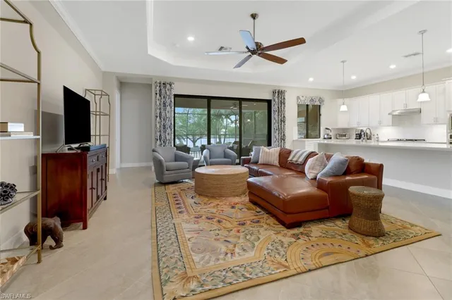 a living room with furniture a window and a flat screen tv