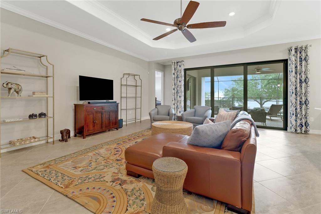 1878 Mustique Street Naples, FL 34120 - Photo 9 of 50 a living room with furniture and a flat screen tv