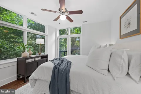 a bedroom with a large bed and a large window