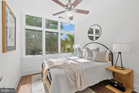 a bedroom with a bed a window and ceiling fan