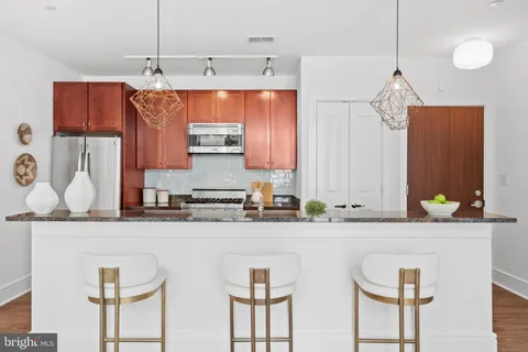 a kitchen with a sink a counter top space cabinets and stainless steel appliances