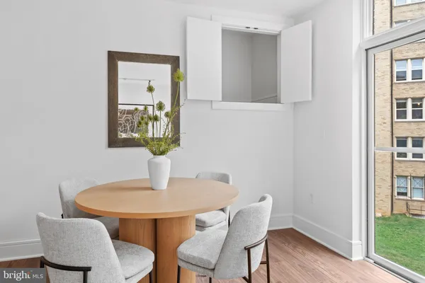 a dining room with furniture and wooden floor