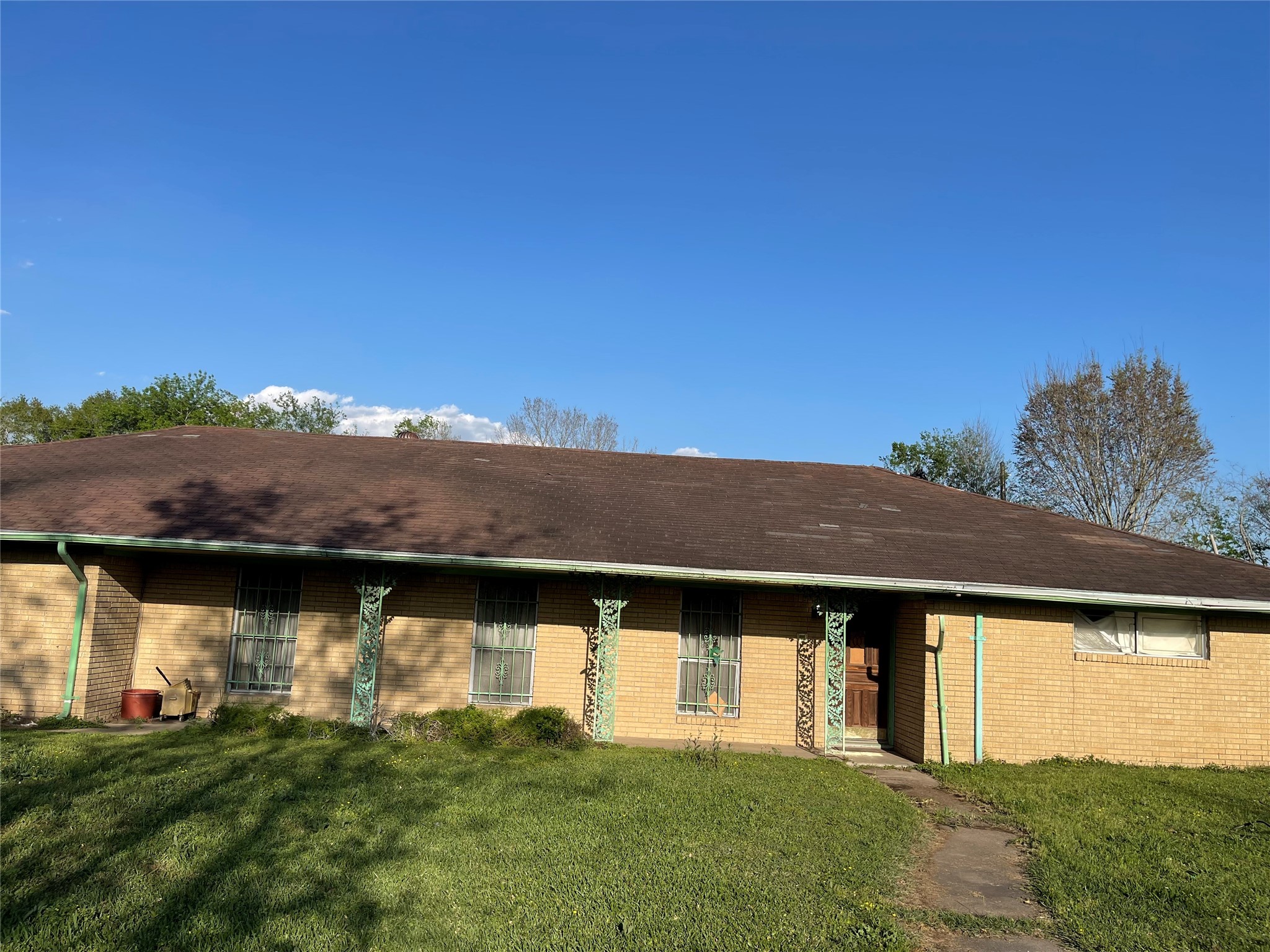 Single Story brick home ,wide facade, covered front entery and decorative ironwork