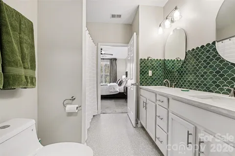 a en suite bathroom with a toilet sink and mirror