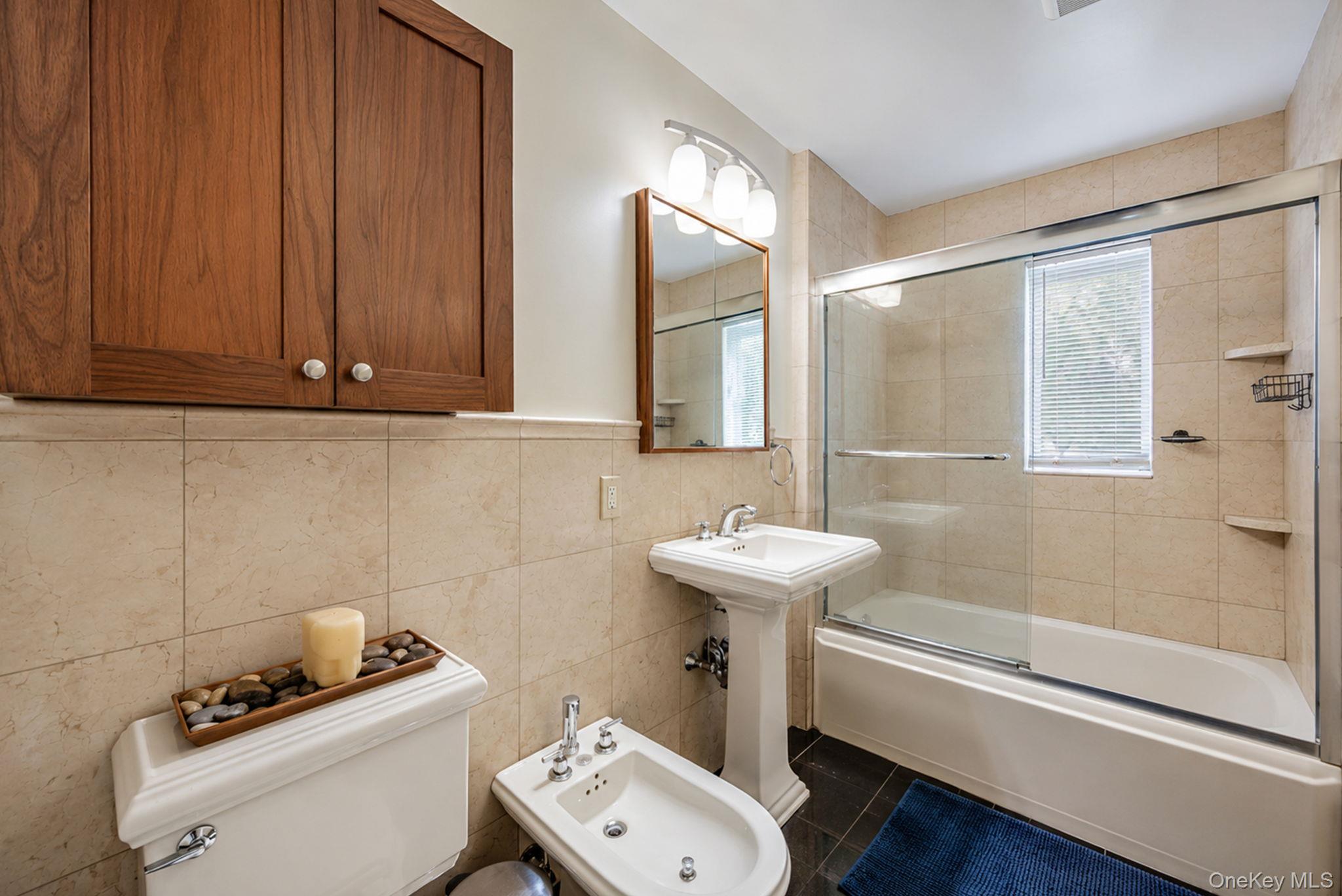 18240 Avon Road Queens, NY 11432 - Photo 11 of 30 Bathroom featuring a pedestal sink, white toilet, and bidet