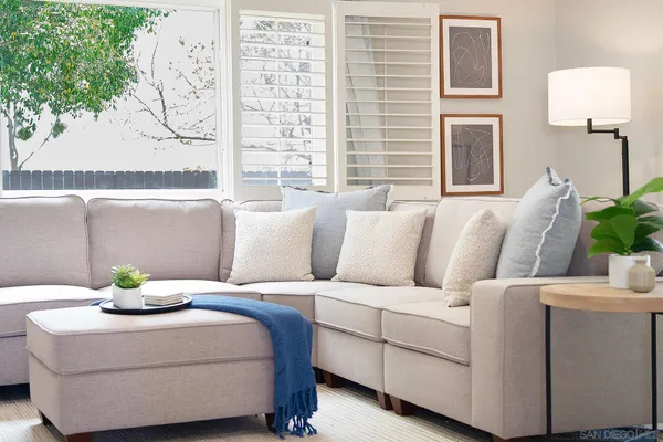 a living room with furniture and a potted plant