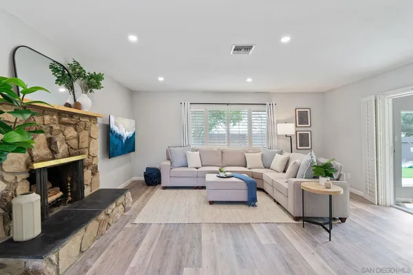 a living room with furniture and a fireplace