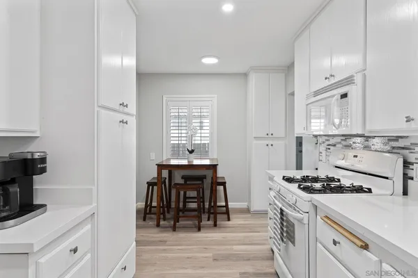a kitchen with a stove a sink and a refrigerator