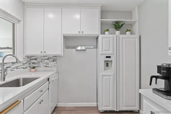 a kitchen with stainless steel appliances white cabinets and a sink