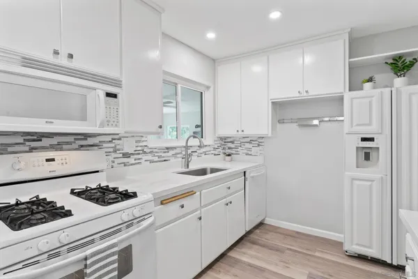 a kitchen with a sink stove and refrigerator