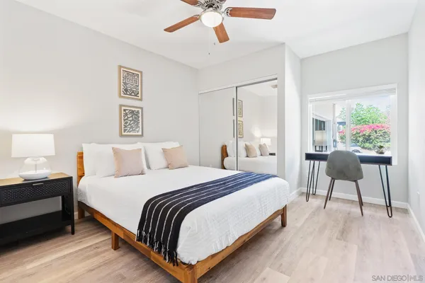 a bedroom with bed and a chandelier