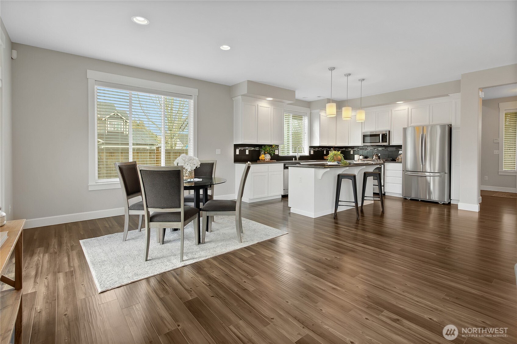 14925 Benton Loop Sumner, WA 98390 - Photo 11 of 40 a view of a dining room with furniture window and wooden floor
